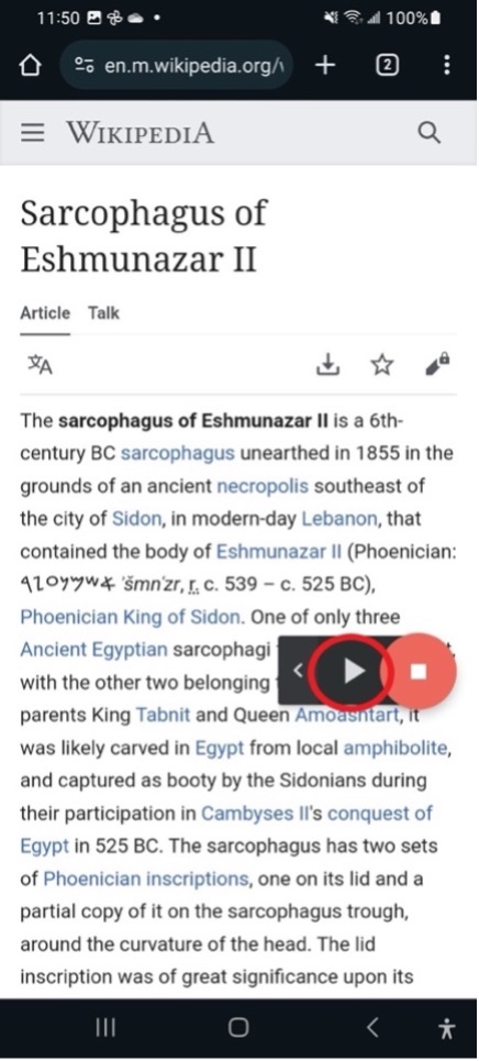 A Wikipedia article on an Android phone with the Select to Speak play and stop buttons floating over the text.